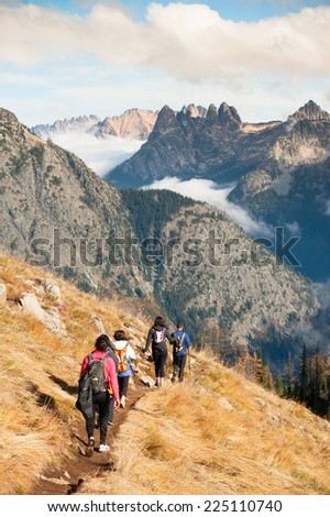 NORTH CASCADES, UNITED STATES - OCTOBER 19, 2014: A group of hikers on the Lake Ann / Maple Pass Loop trail in the North Cascades of Washington State during a rare spell of pleasant fall weather.
