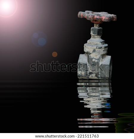 Old Water valve with reflected in water