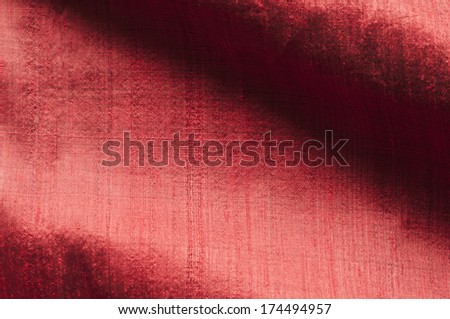 Background of red raw silk with textured effect.