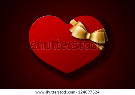 Heart-shaped red gift box with golden bow on dark background. A Valentine\'s Day gift / wedding gift.