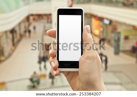 Smartphone with empty screen in woman hand in a shopping center - shopping application display