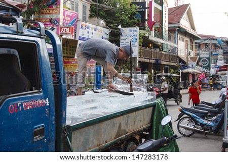 SIEM REAP, CAMBODIA - APRIL 21: An ice seller in downtown Siem Reap on April 21, 2013. Ice is sold to the restaurant of pub street because fridge are uncommon in Siem Reap
