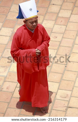 TAY NINH, VIETNAM - APRIL 22: red priest in a Caodai temple in Vietnam. Caodai is a Vietnamese religion mixing different religions from around the world on April 22, 2014.