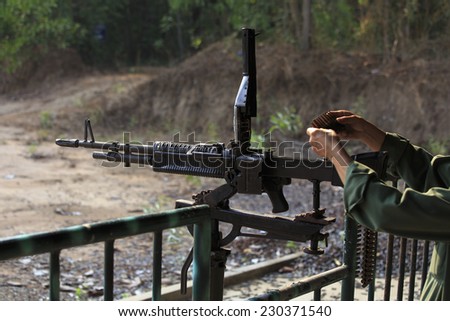CHU CHI TUNNELS, VIETNAM - 22 APRIL: A man is preparing an M60 rifle down a shooting range on April 22, 2014. This is very popular and many people each year attend.