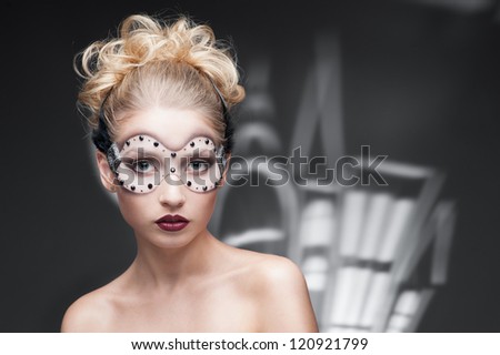 beauty portrait of young caucasian blond woman in fantasy make-up over cartoon style houses on background