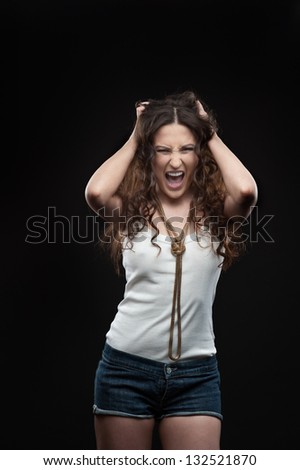 screaming casual brunette woman over black background