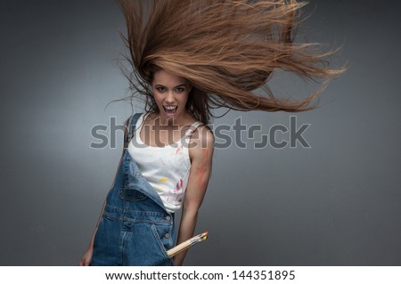 crazy painter woman screaming over gray background