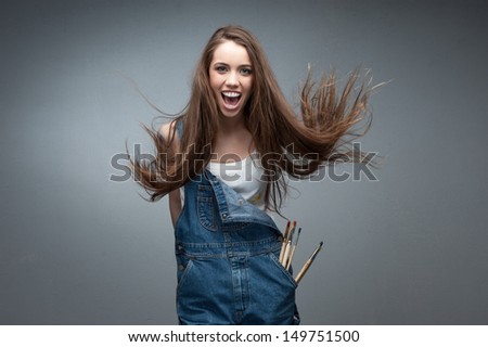 crazy painter woman screaming over gray background