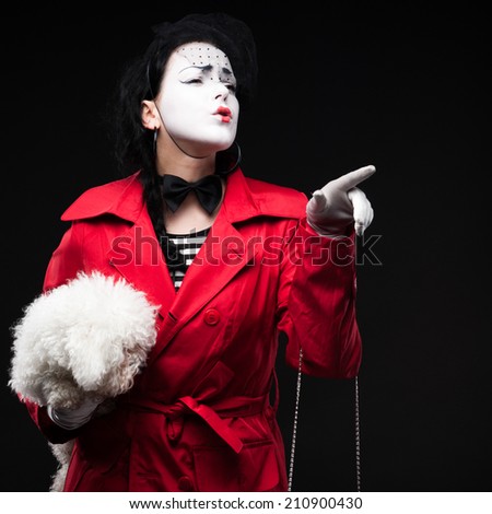 funny woman mime holding small fluffy dog and showing emotions