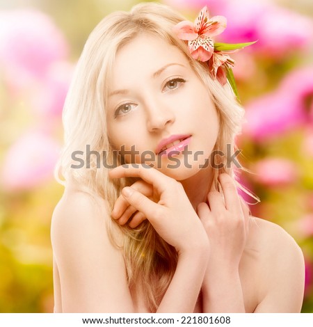 beautiful young woman with flowers in hair over autumn background