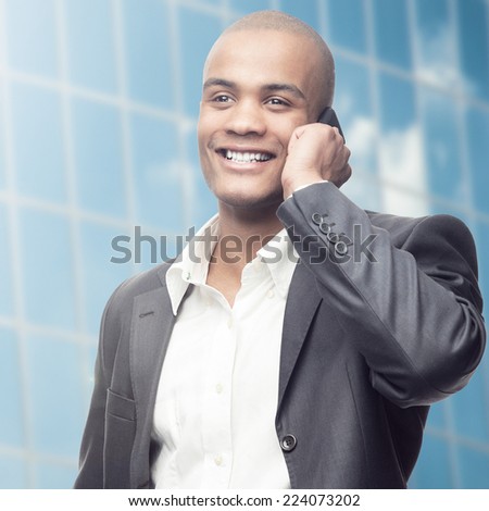 successful young african businessman standing over blue background