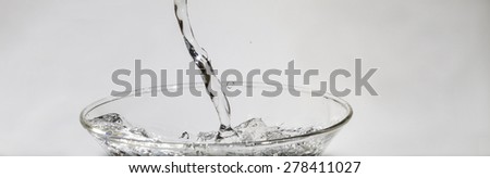 Water splashing from glass isolated on white background