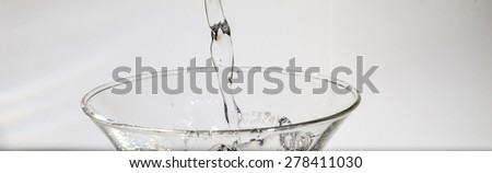 Water splashing from glass isolated on white background
