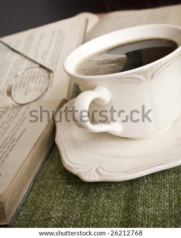 closeup to cup of coffee and books