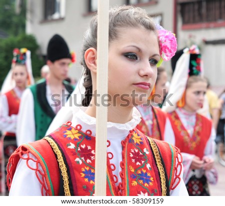 SZCZYRK, POLAND–AUGUST 1: Participants of the 47th Beskidy Highlanders Week of Culture (TKB), the biggest folk culture event in Eastern Europe, parade through the city, folk group from Bulgaria on August 1, 2010 in Szczyrk, Poland