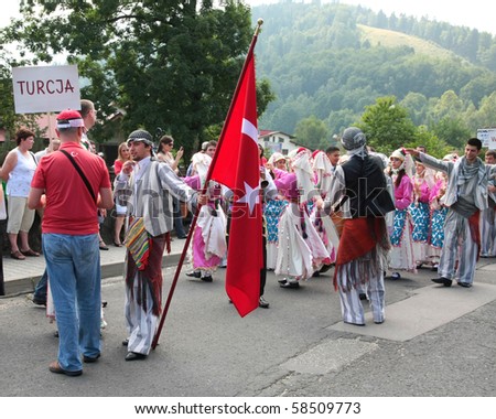 SZCZYRK, POLAND - AUGUST 1: Participants of the 47th Beskidy Highlanders Week of Culture (TKB), the biggest folk culture event in Eastern Europe, parade through the city, folk group from Turkey on August 1, 2010 in Szczryk