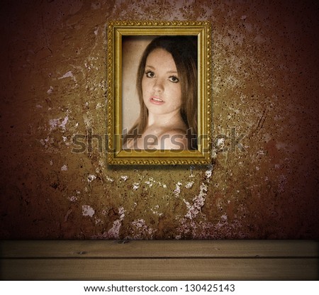 grunge interior with portrait of young lady in golden frame