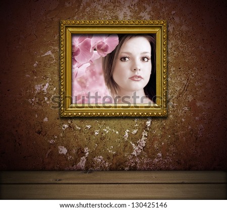 grunge interior with portrait of young lady in golden frame