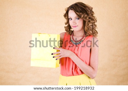 young colorful dressed woman with color shopping bag