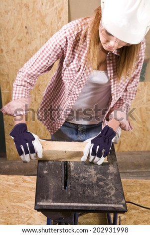 young woman working as wood builder