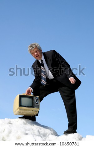 Businessman carrying an old TV