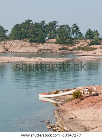 White canoe on a pink rock