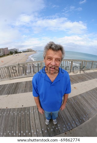 Smiling man on a pier - shot with a fish-eye lens