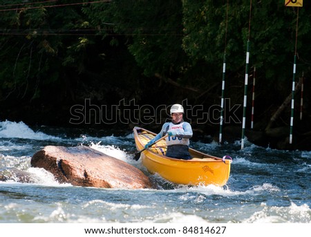 MINDEN, ONTARIO - SEPT. 10 : An unidentified contestant competes at Open Canoe Slalom Race, on September 10, 2011 at Gull River in Minden, Ontario, Canada.