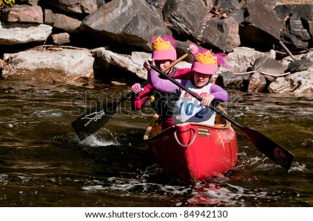 MINDEN, ONTARIO - SEPT 10. Two unidentified female contestants compete at Open Canoe Slalom Race, on September 10, 2011 at Gull River in Minden, Ontario, Canada. Sept. 10, 2011