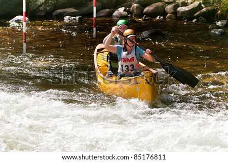 MINDEN, ONTARIO - SEPT 10: Two unidentified female contestants compete at Open Canoe Slalom Race, on September 10, 2011 at Gull River in Minden, Ontario, Canada.