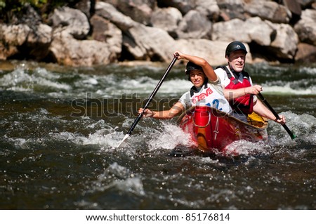 MINDEN, ONTARIO - SEPT 10:  Two unidentified contestants compete at Open Canoe Slalom Race, 2011 at Gull River in Minden, Ontario, Canada.