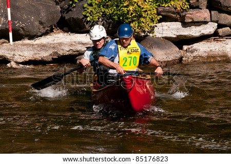 MINDEN, ONTARIO - SEPT 10: Two unidentified contestants compete at Open Canoe Slalom Race, 2011 at Gull River in Minden, Ontario, Canada.