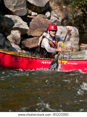 MINDEN, ONTARIO - SEPTEMBER 10: An unidentified contestant competes at 2011 Open Canoe Slalom Race at Gull River in Minden, Ontario, Canada on September, 10, 2011.