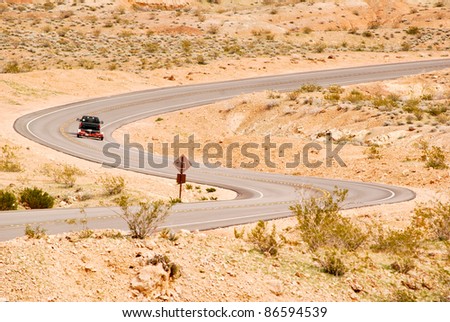 Truck with a boat trailer on a winding desert road