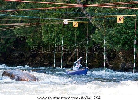 MINDEN, ONTARIO - SEPTEMBER 10: An unidentified contestant competes at 2011 Open Canoe Slalom Race at Gull River in Minden, Ontario, Canada on September 10, 2011.