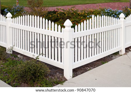 Corner section of a white picket fence