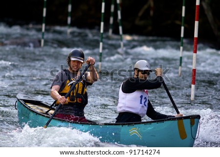 MINDEN, ONTARIO - SEPT. 11 : Two unidentified contestants compete at Open Canoe Whitewater Slalom, 2011 at Gull River on September 11, 2011 in Minden, Ontario, Canada.