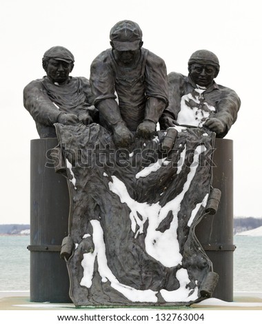 PORT DOVER-MARCH 16: Fishermen Monument on March 16, 2013 in Port Dover, Ontario. The sculpture is dedicated to commercial fishermen who lost their lives on Lake Eerie and located near the lighthouse