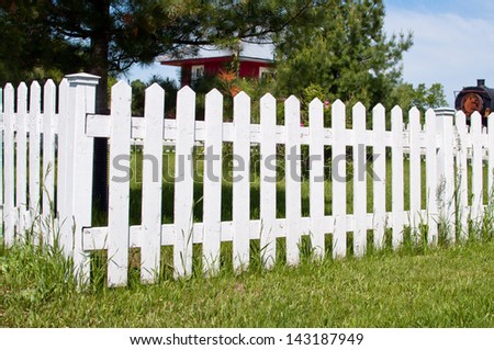Old railway station and a white picket fence