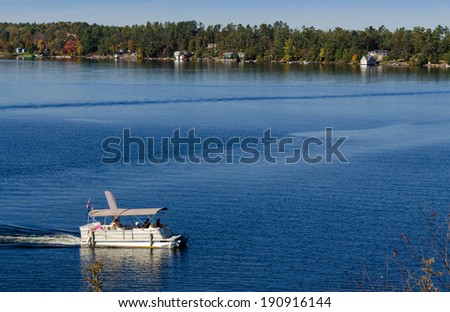 Pontoon boat on a blue lake