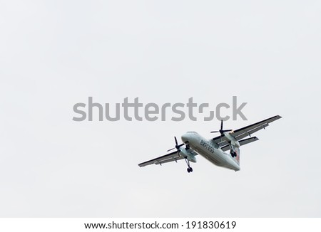 TORONTO INTERNATIONAL AIRPORT - MAY 9, 2014: Canada Express turboprop plane with engaged landing gear landing at Toronto Pearson International airport.