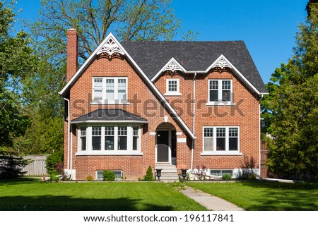 Red brick house with a bay window