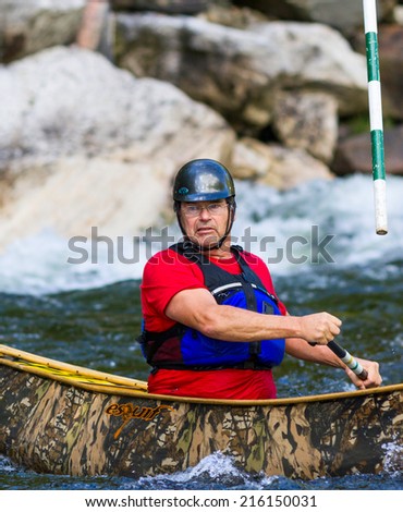 MINDEN, ONTARIO - SEPTEMBER 6, 2014: An unidentified contestant competes at 2014 Open Canoe Slalom Race at Gull River in Minden, Ontario, Canada.