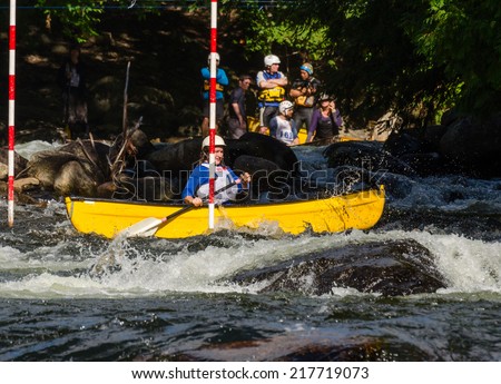 MINDEN, ONTARIO - SEPTEMBER 6, 2014: Female contestant competes at 2014 Open Canoe Slalom Race at Gull River in Minden, Ontario, Canada.