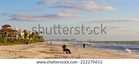 NAPLES, FLORIDA - NOVEMBER 4, 2011: Tourists enjoying the beach in Naples, Florida. Naples is located on the Gulf Coast in southern Florida.