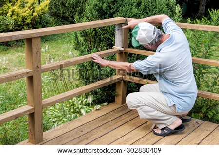 Man fixing a deck railing