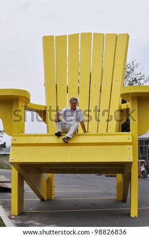 Man sitting on a giant chair