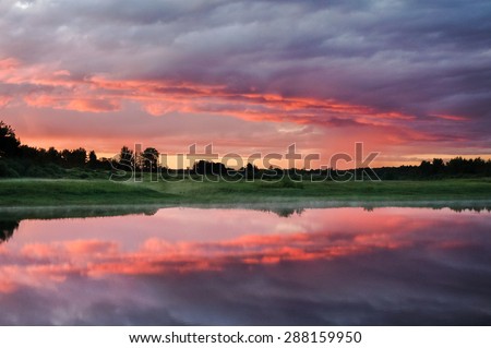 beautiful sunrise sunset with red sky mirrored sky in the river water