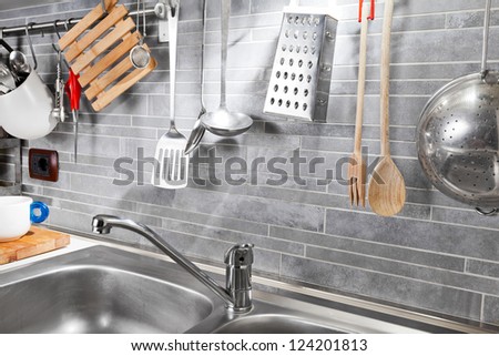 Kitchen tools on a grey tile marble wall from above
