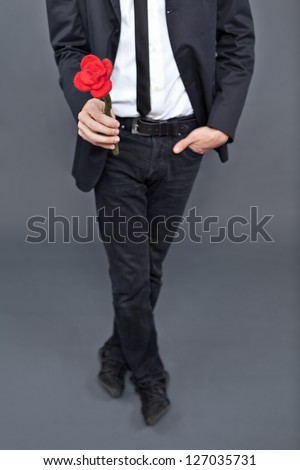 Boy with jacket is donating a fabric red rose